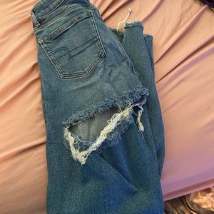 jeans ripped in knees and one rip in the back